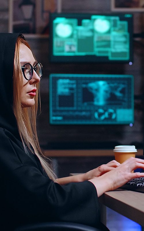 female-hacker-wearing-a-hoodie-using-a-dangerous-v-XLRB4XRa.jpg